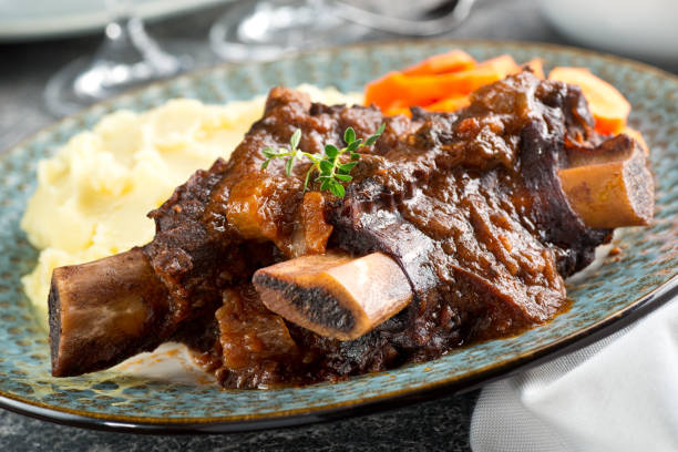 Delicious braised beef ribs with mashed potato and carrots.